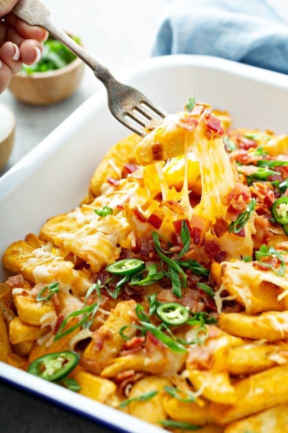 Cheesy breakfast potatoes with crispy sautéed potatoes, onions, melted cheese, and smoky chipotle crema — served at La Neta Mexican restaurant in Downtown Summerlin, Las Vegas.